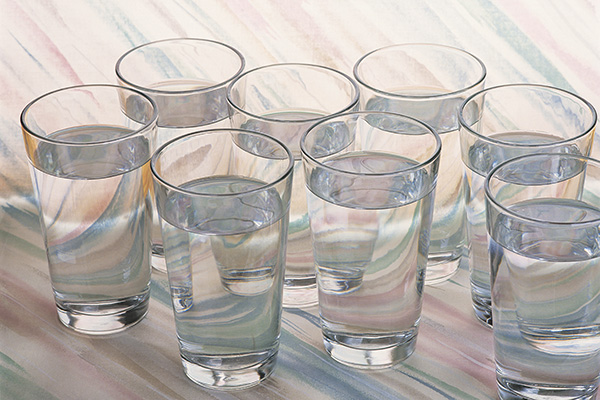 Several glasses of clean water on a table