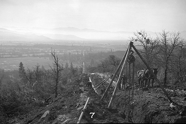 historical image of a surveyor on the ridgeline