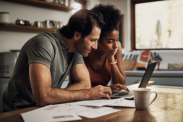 Man and woman looking on line at a bill.